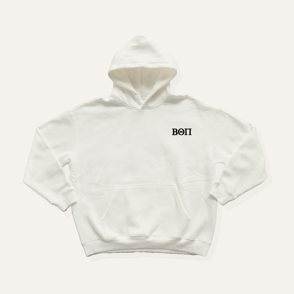 White hoodie on a cream background with 'Beta Theta Pi' greek letters in black on the left side chest.
