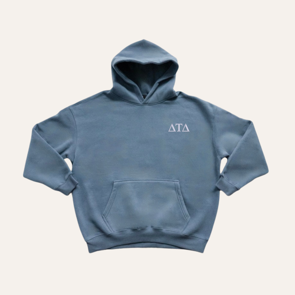 Dusty blue hoodie on a cream background with 'Delta Tau Delta' greek letters in white on the right side chest.