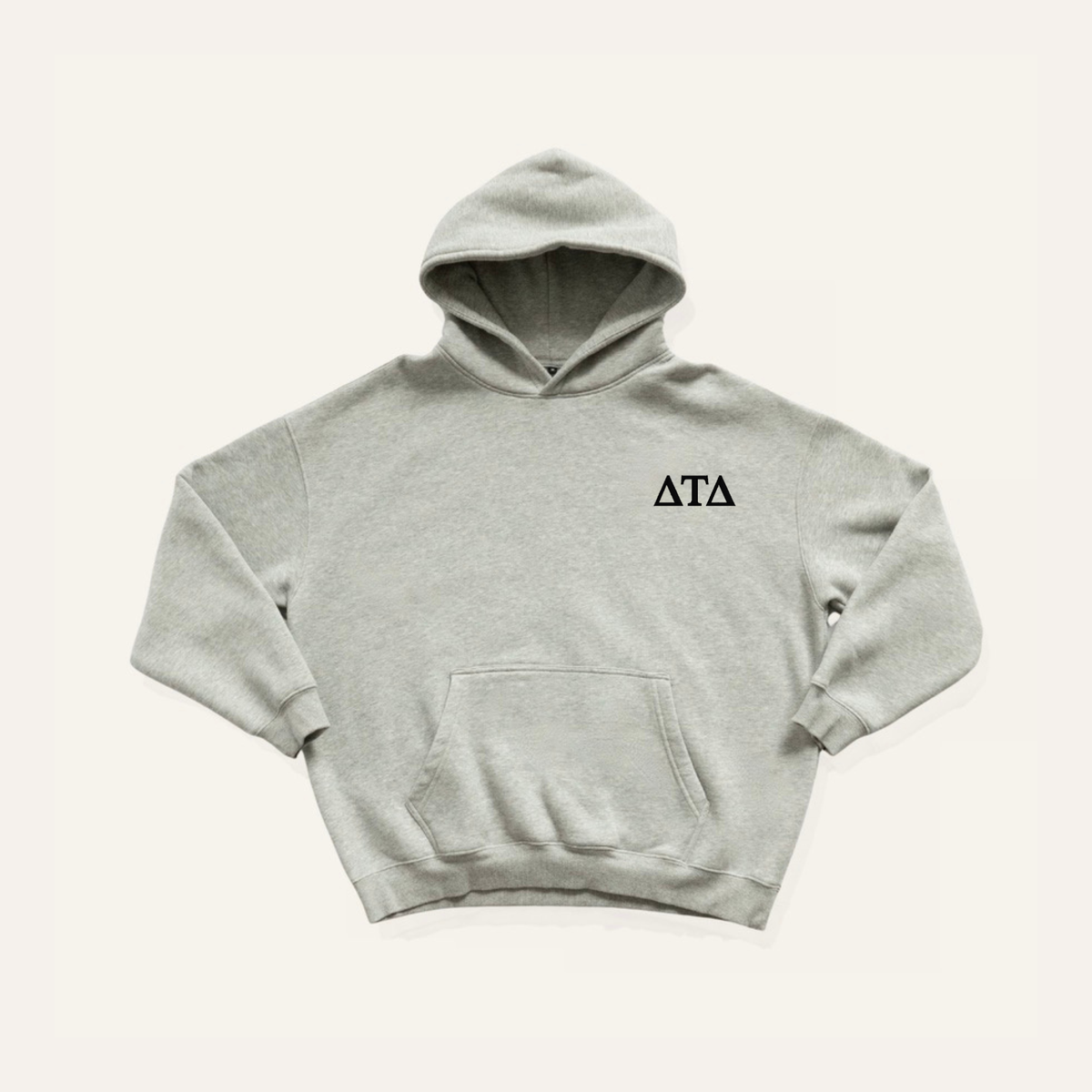 Light grey hoodie on a cream background with 'Delta Tau Delta' greek letters in black on the right side chest.