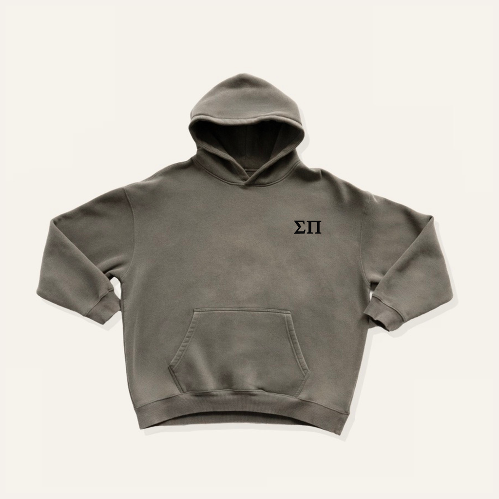 Dark gray hoodie on a cream background with 'Sigma Pi' greek letters in black on the left side chest.