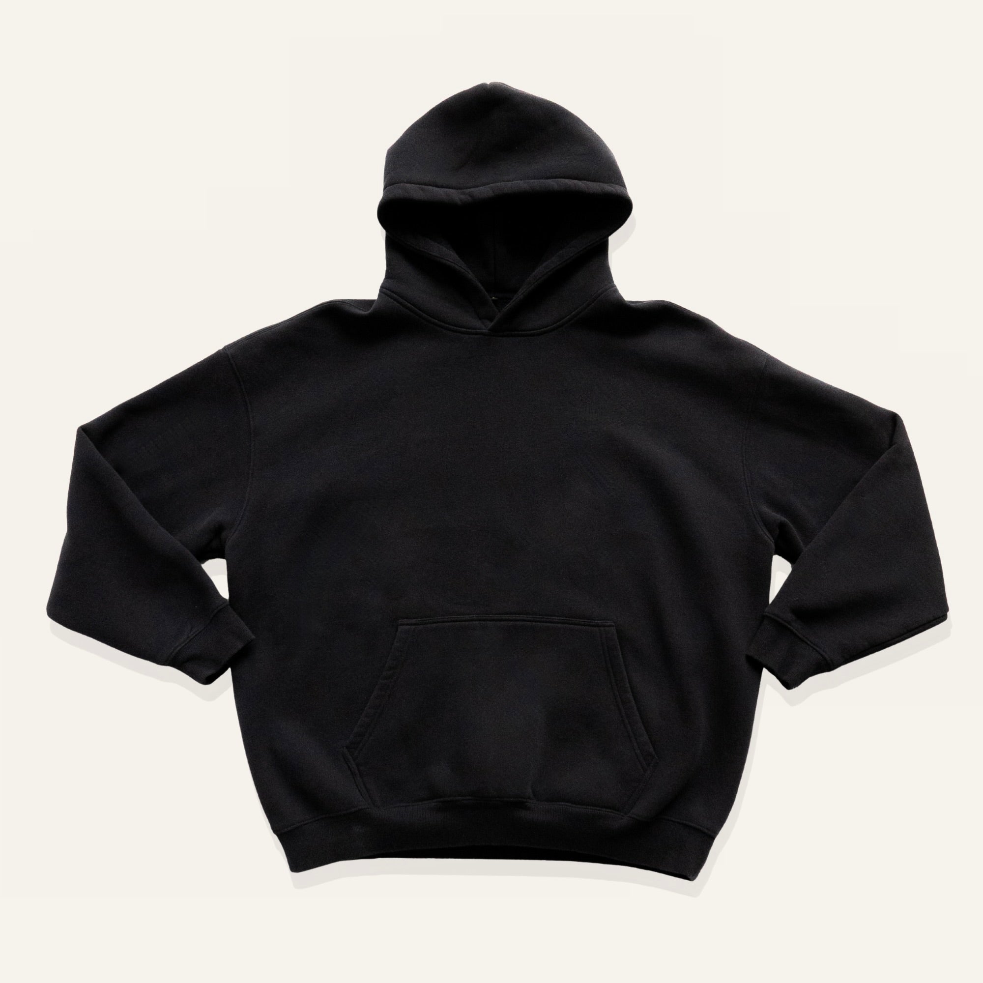 Black hoodie on a cream background