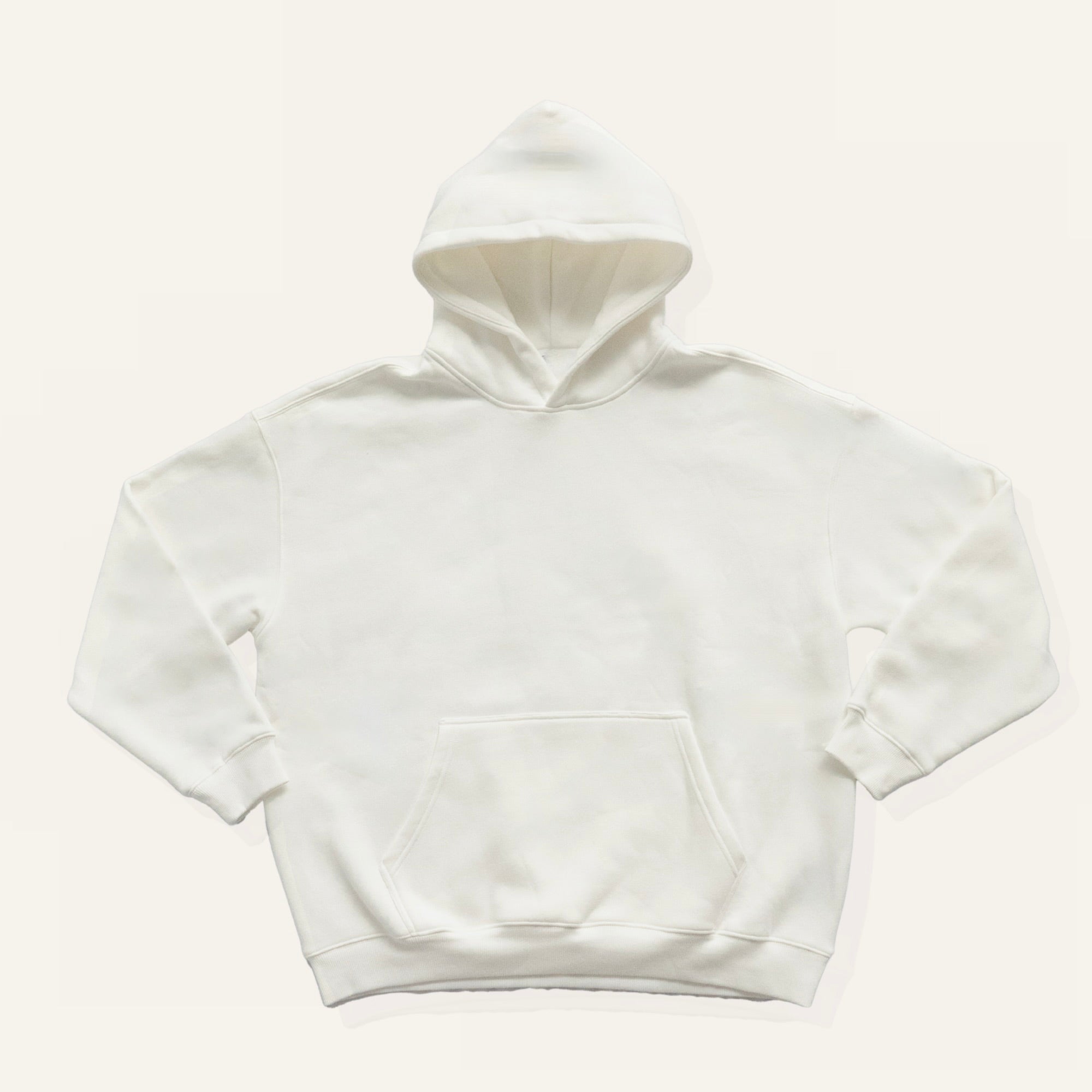 White hoodie on a cream background
