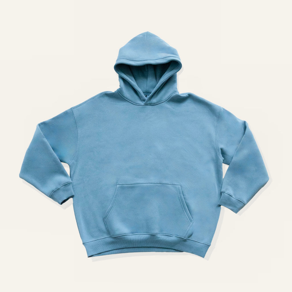 Blue hoodie on a cream background