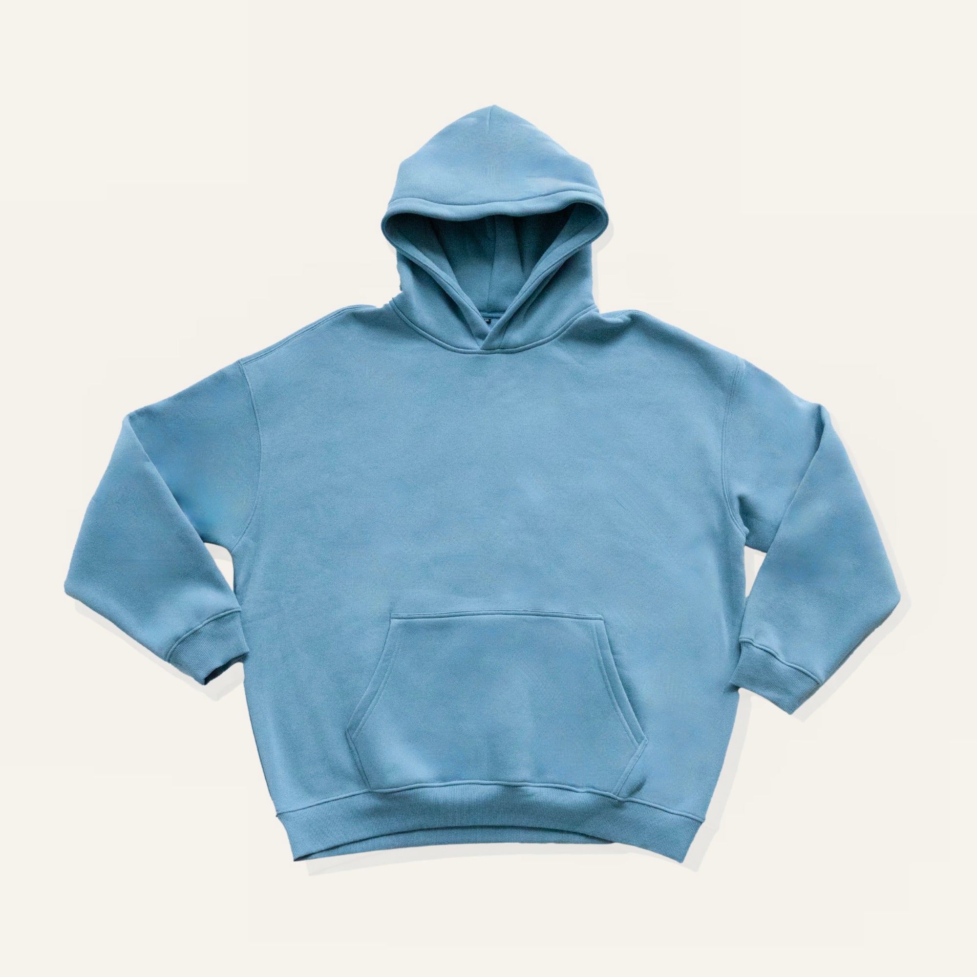 Blue hoodie on a cream background