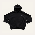 Black hoodie on a cream background with 'Delta Sigma Phi' greek letters in white on the right side chest.