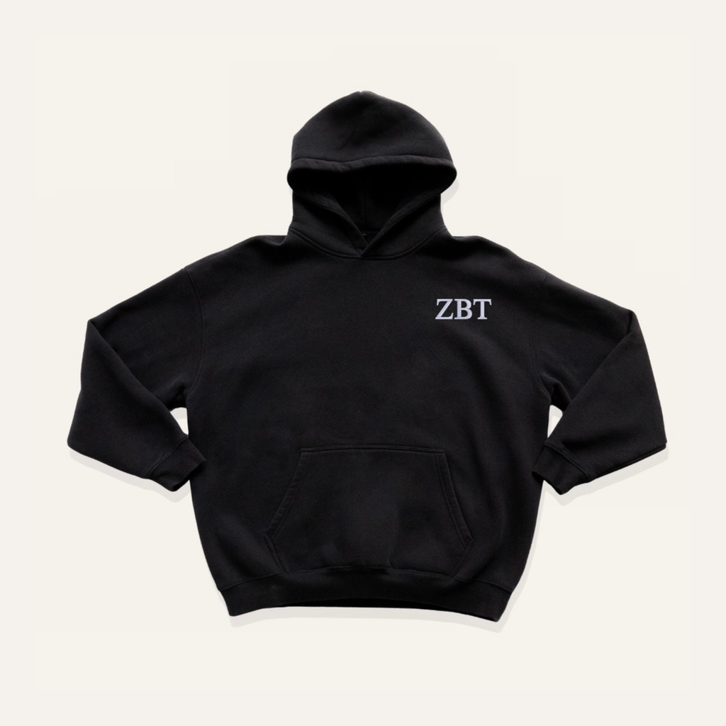 Black hoodie on a cream background with 'Zeta Beta Tau' greek letters on the right side near the hood in white lettering.