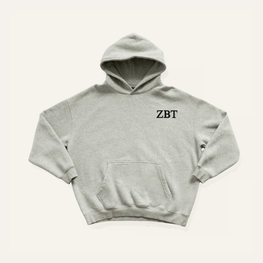 Light grey hoodie on a cream background with 'Zeta Beta Tau' greek letters on the right side near the hood in black lettering.
