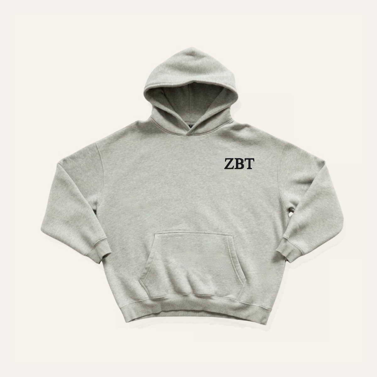 Light grey hoodie on a cream background with 'Zeta Beta Tau' greek letters on the right side near the hood in black lettering.